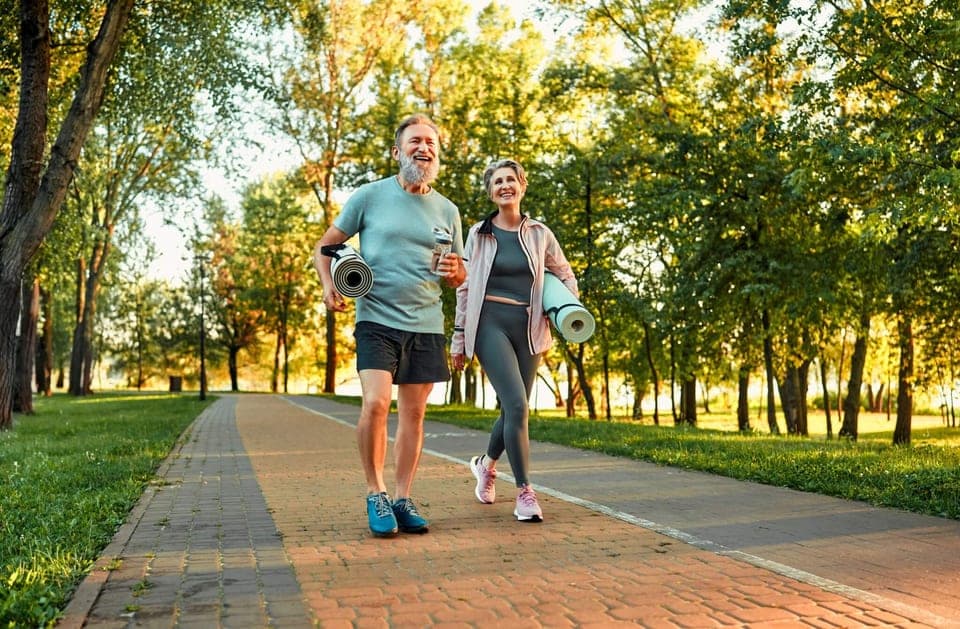 Two adults walking together outdoors during an active conversation