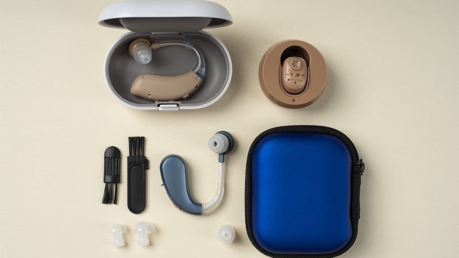 Starter hearing aid kit with behind-the-ear and in-the-ear devices, cleaning tools, ear tips, and a carrying case