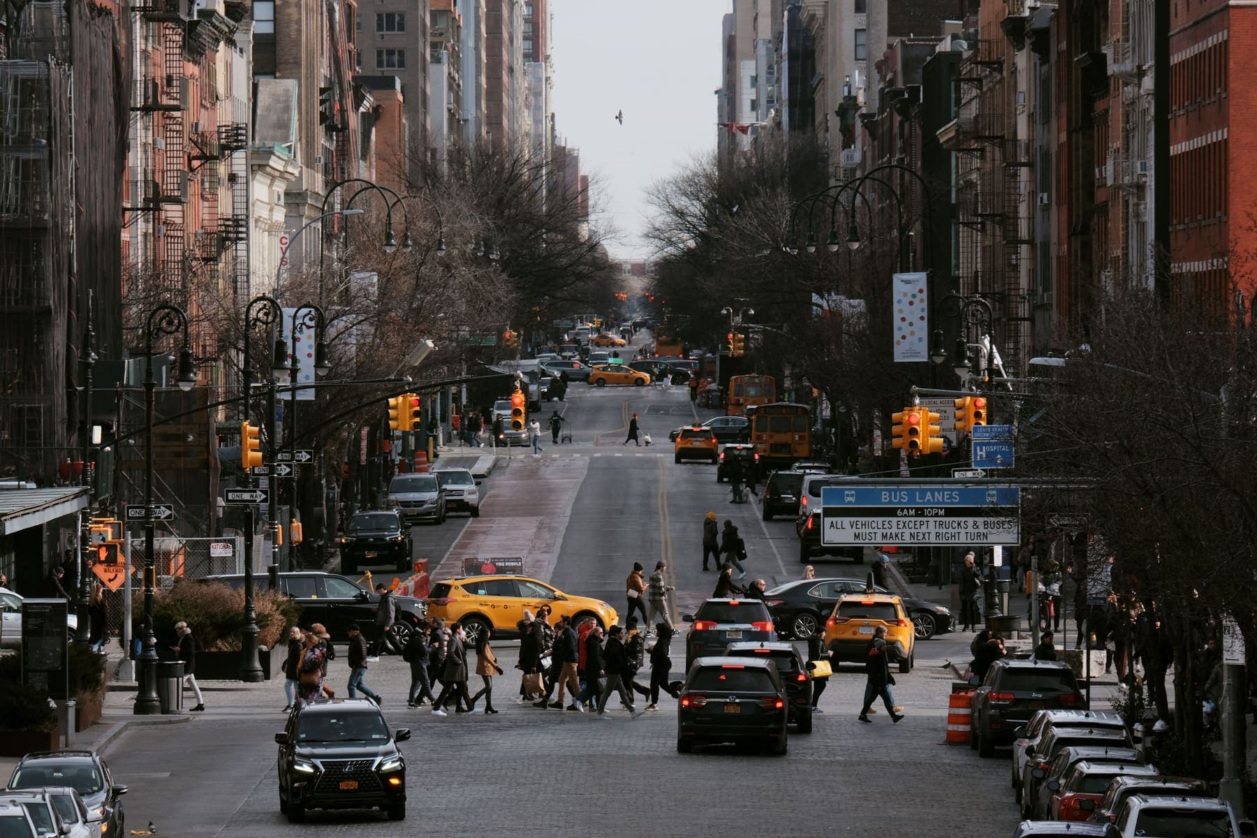 Busy Bronx street scene with pedestrians and tall buildings