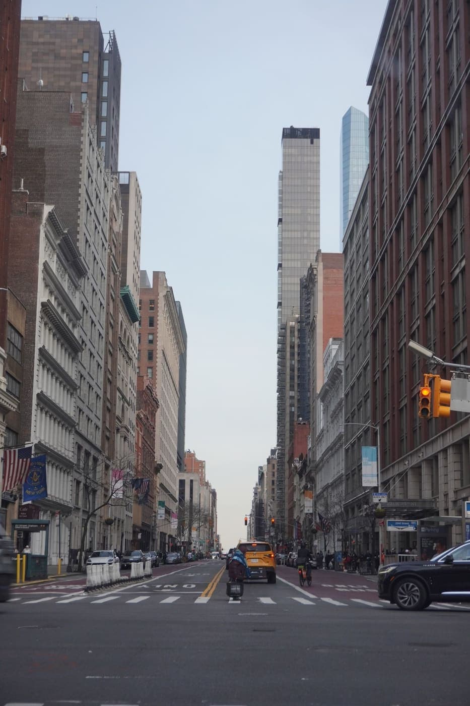 Manhattan street lined with tall buildings and city traffic