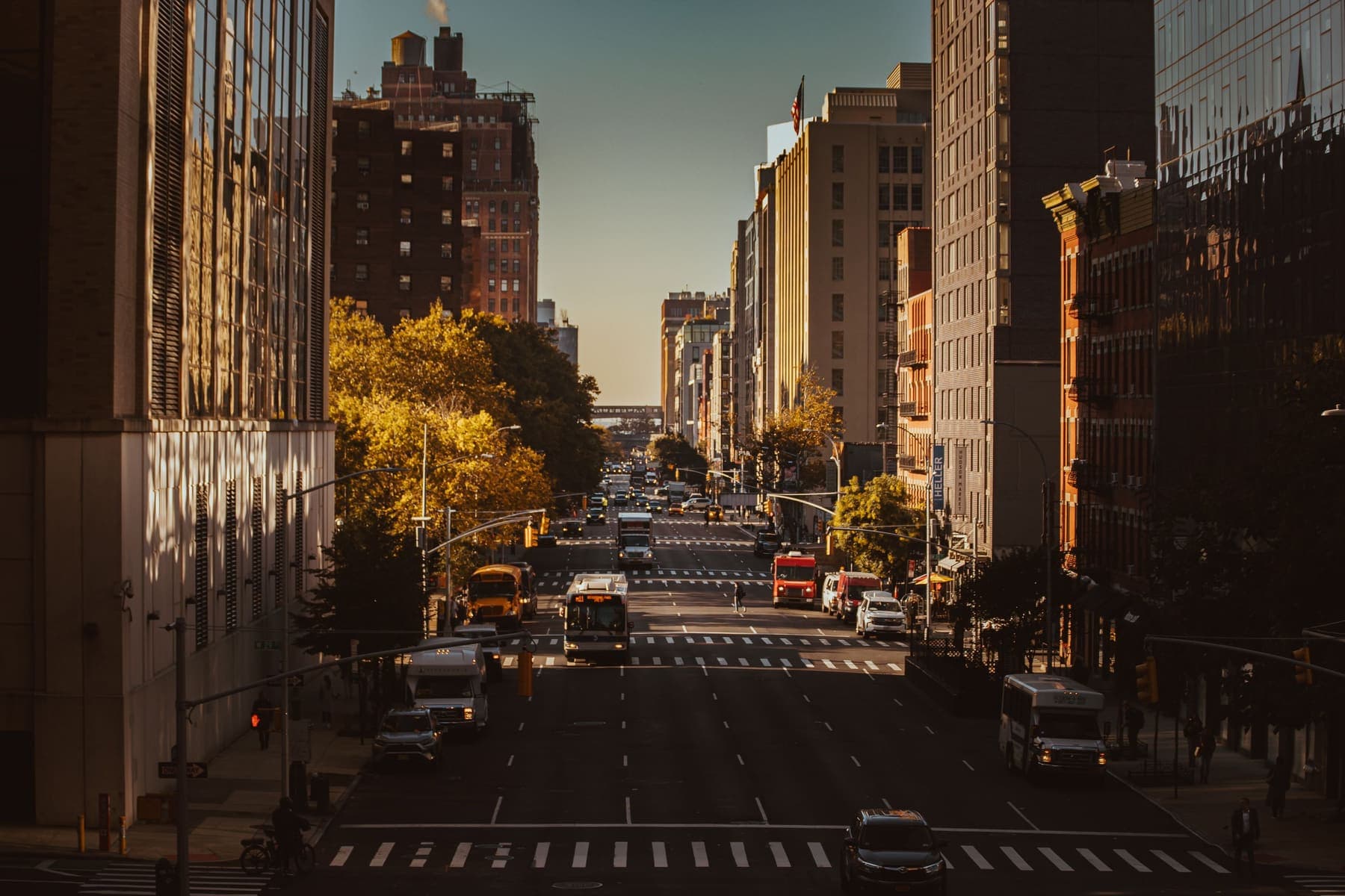 Busy New York City street with tall buildings and morning light