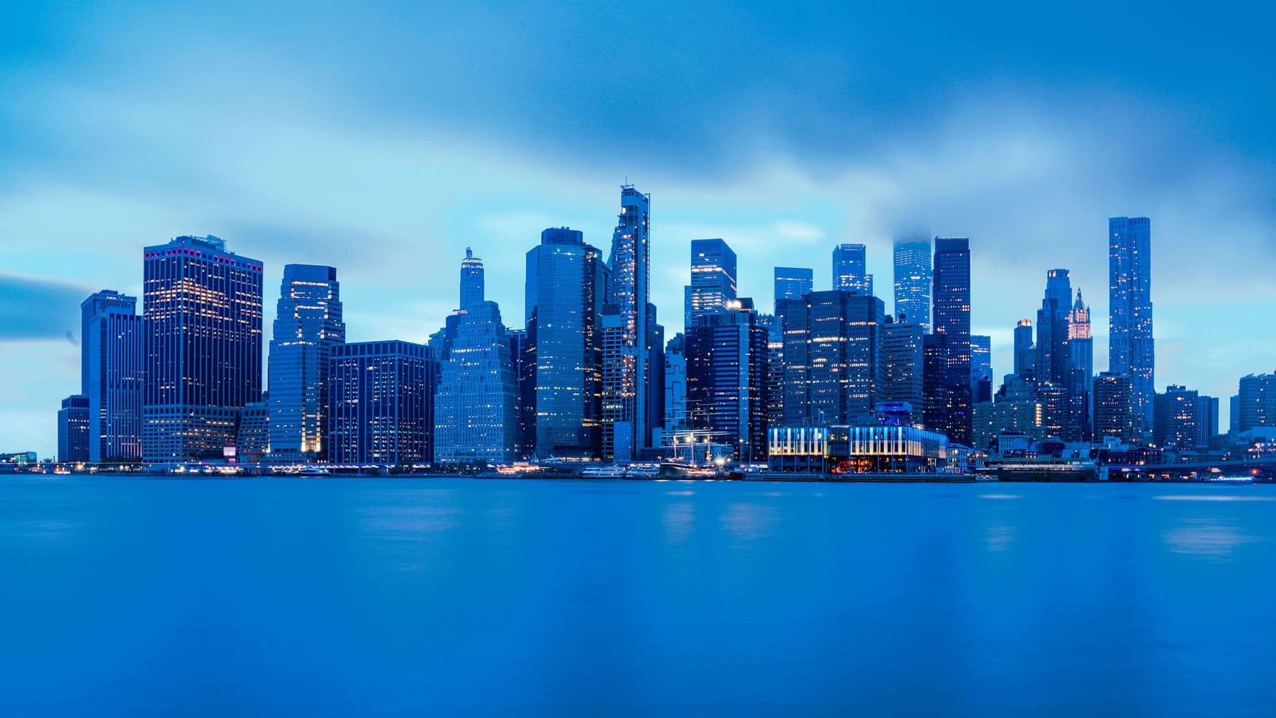 New York City skyline seen across the water from a waterfront area